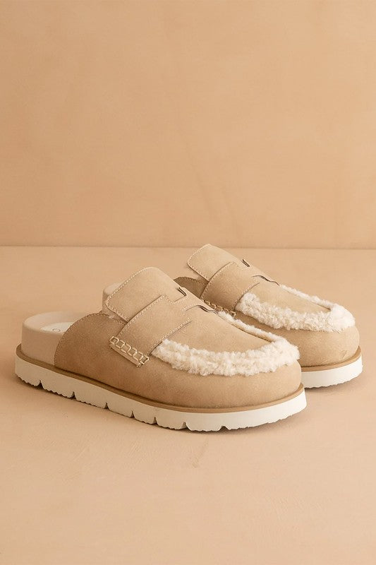 Front angled view of Avalon Khaki suede loafer mules with fluffy shearling trim and cushioned slip-on design.