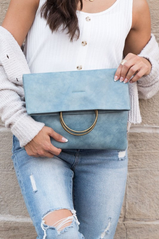 late blue Safara Fold-Over O-Ring Clutch in smooth vegan leather with bronze accent rings.