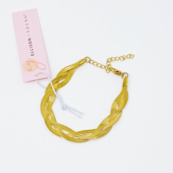 Braided Herringbone Chain Bracelet gold, flat lay with brand tag showing lobster clasp and extender.