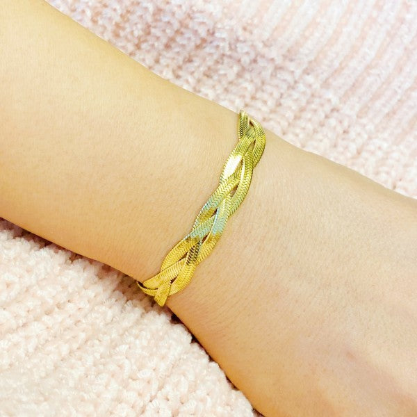 Braided Herringbone Chain Bracelet in gold, three-strand weave, adjustable fit shown on wrist.