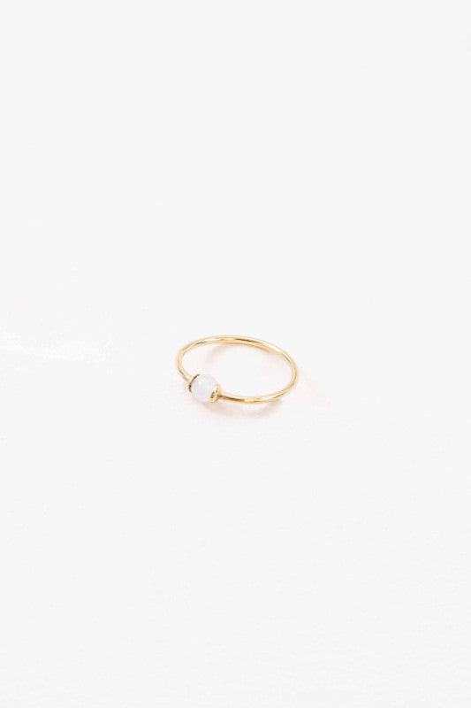 Becca White Stone Ring dainty gold band with polished white stone centerpiece, front view