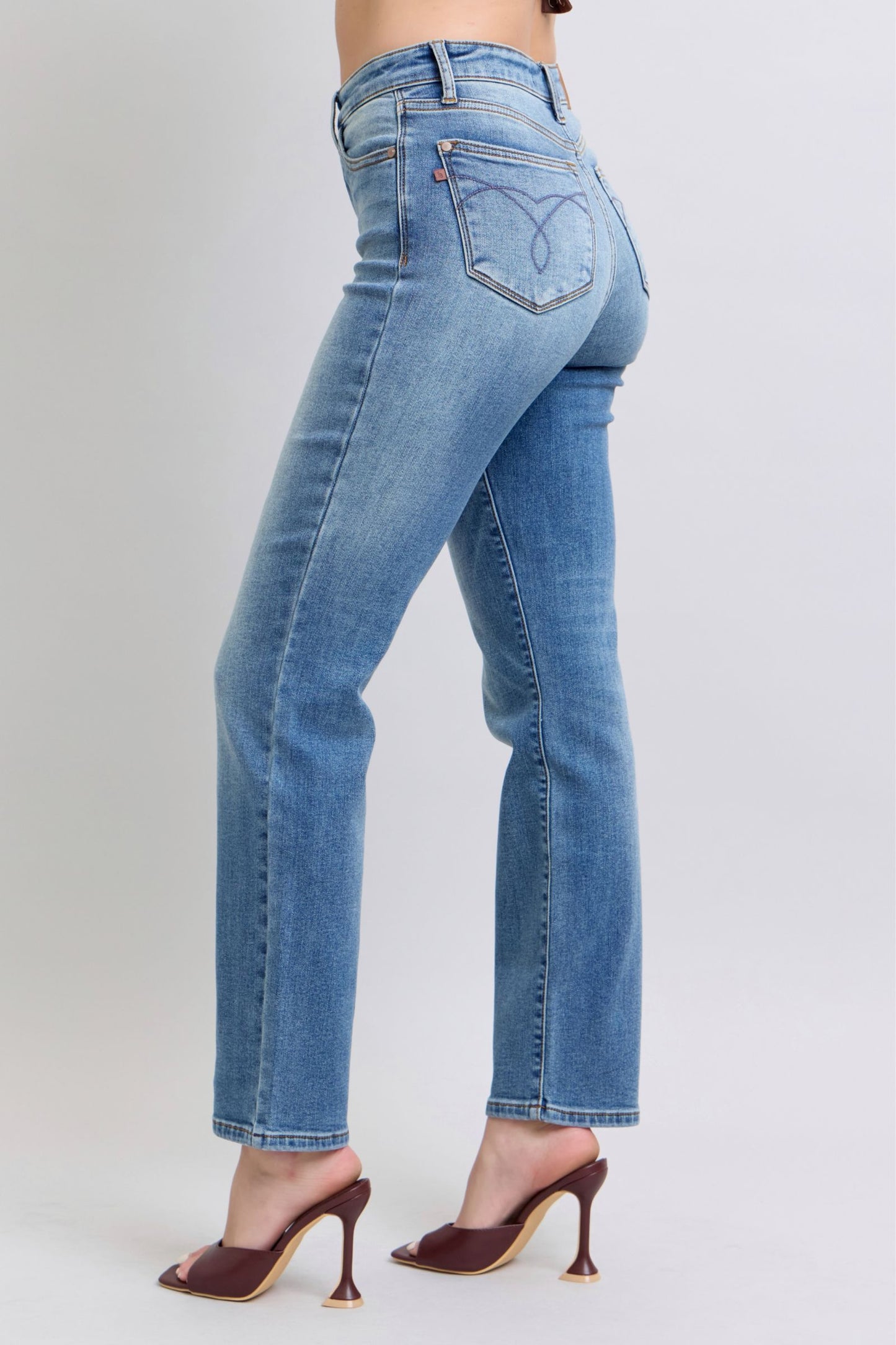 Side profile of Judy Blue straight-leg jeans in medium wash, thermal washed design for casual style.
