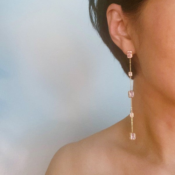 Woman wearing blush pink Five Stones Dangle Drop Earrings