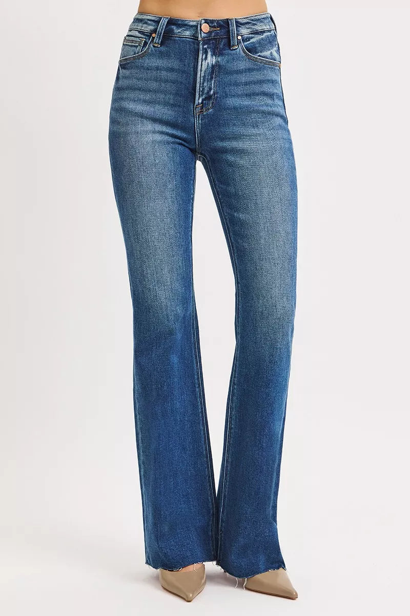 Model standing in Seraphina High Rise Flare Jeans, trendy dark wash flare style.