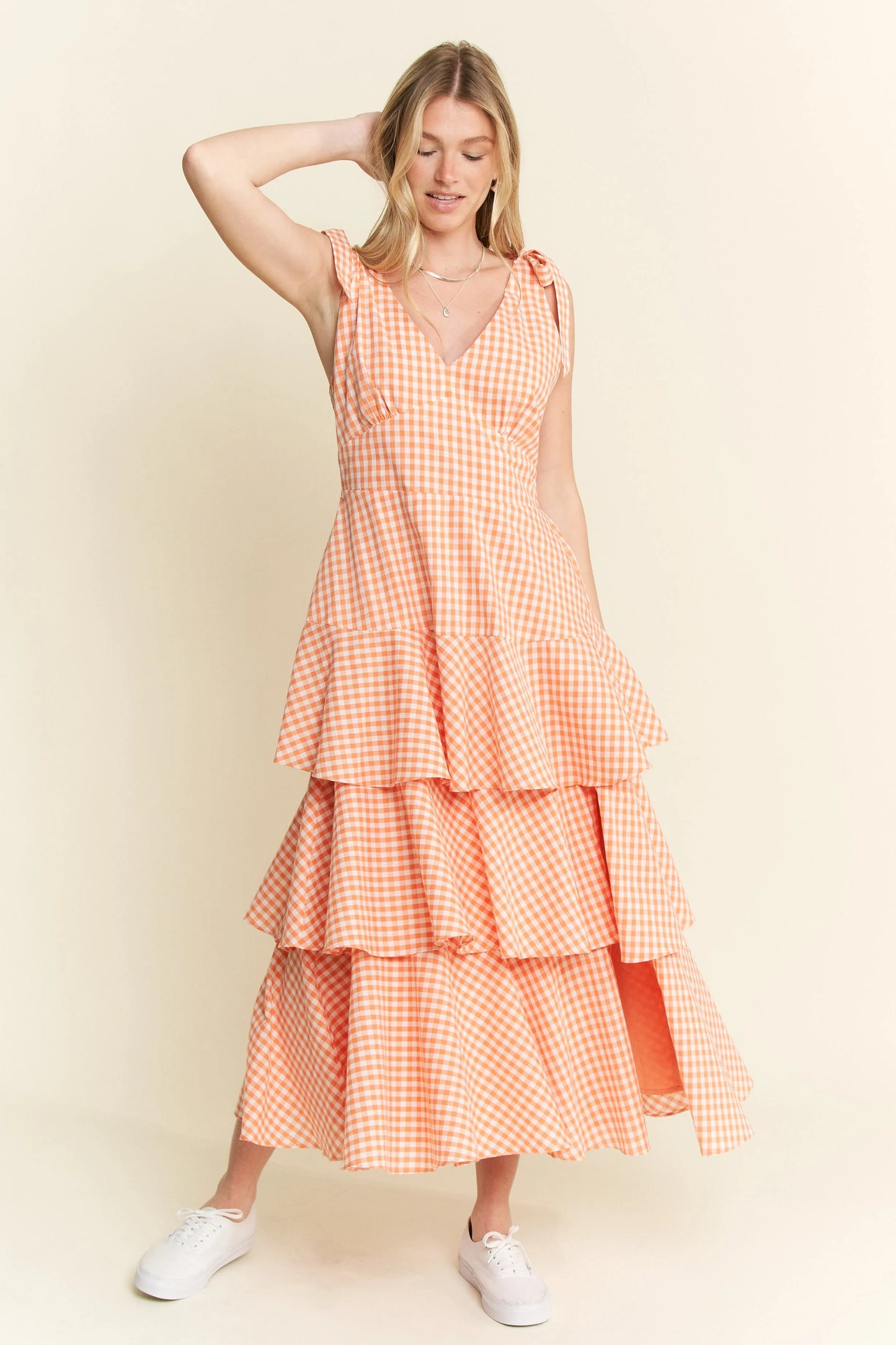 Front view of Alice Gingham Tiered Midi Dress by Jade by Jane, featuring playful orange gingham print, halter tie straps, and flirty tiered skirt.
