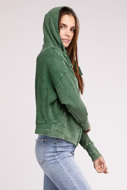 Model wearing Dark Green Hanna Hooded Jacket with hood up, showing slouchy design.