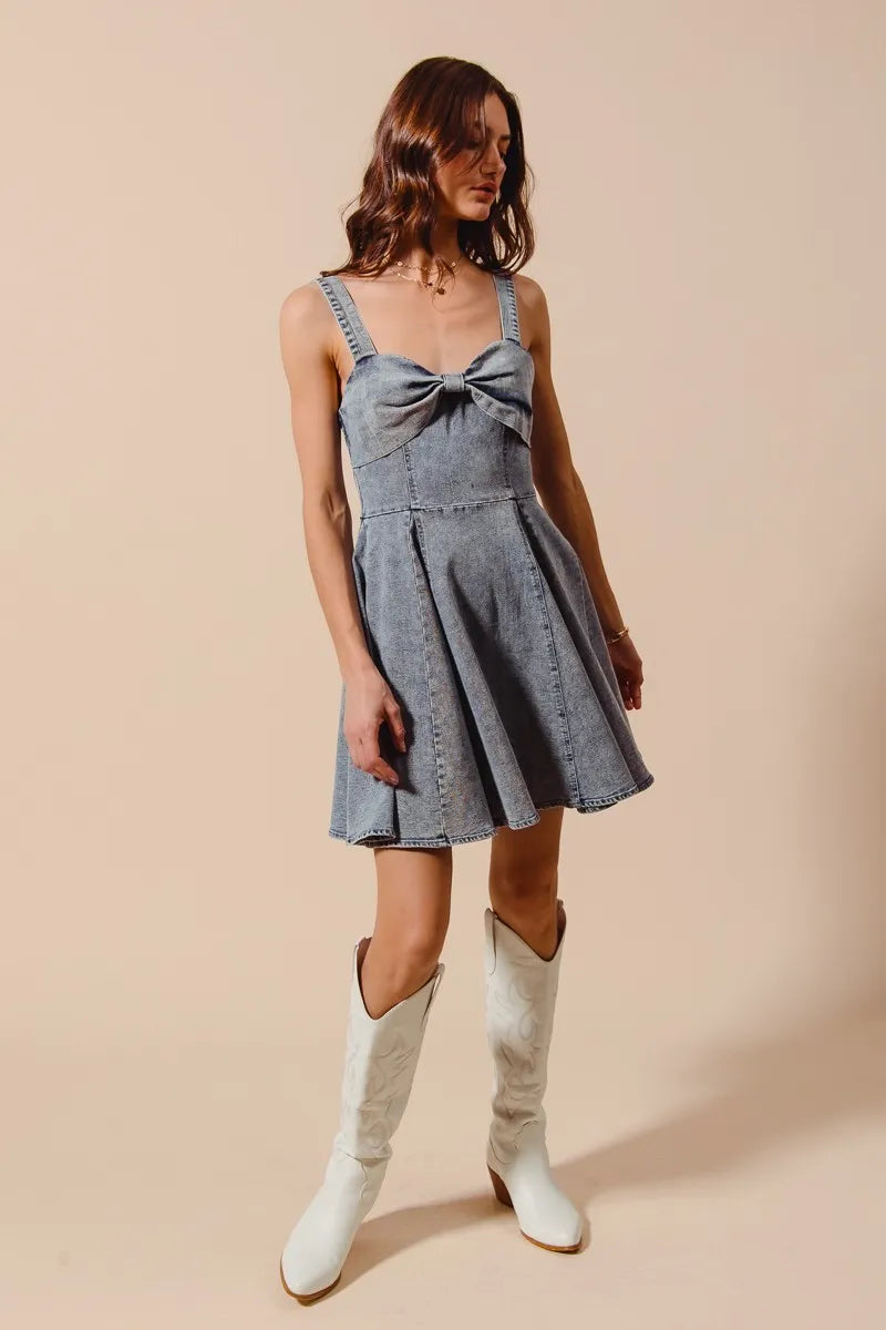 Full body image of model in Cassidy dress and cowboy boots, emphasizing movement and western flair.