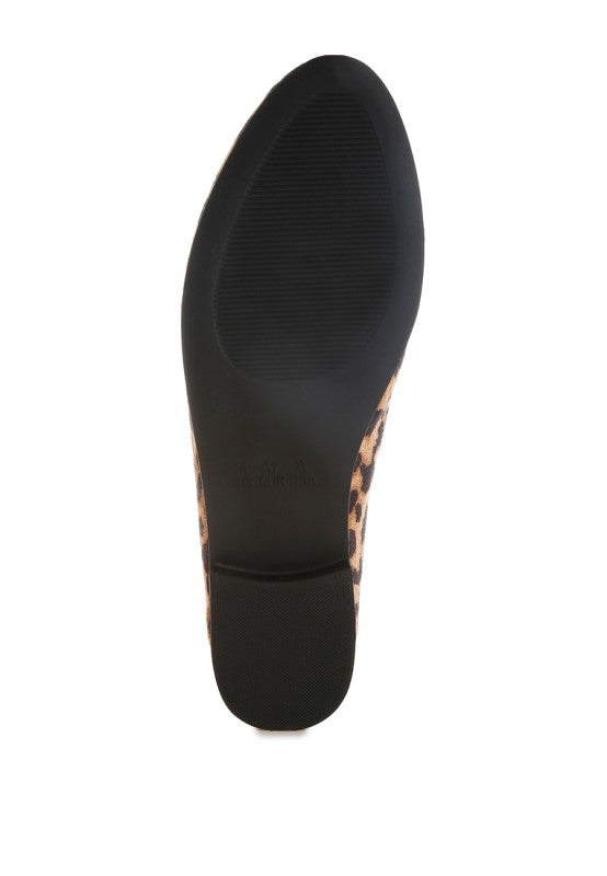 Bottom view of TP rubber sole on leopard print flat loafer for women.