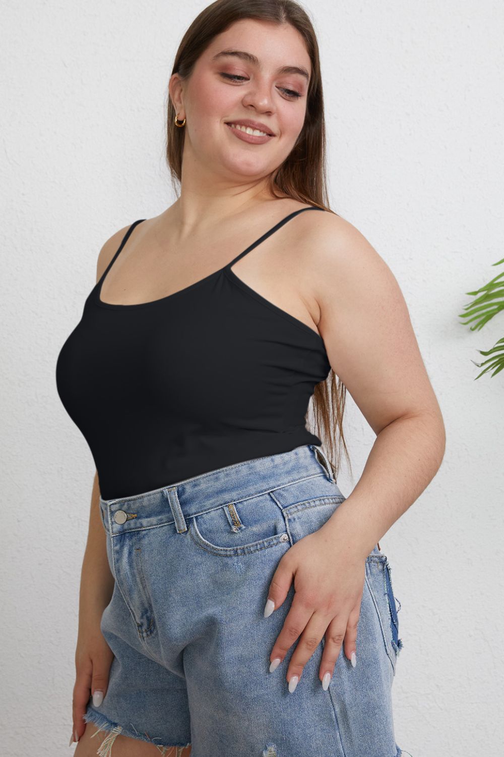 Plus size model in black Winetta Slim Cami, side angle showing stretch fit.