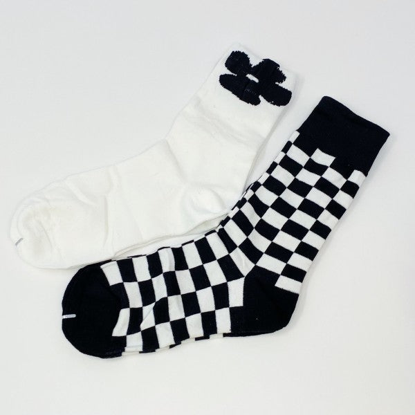 Flat lay of Insiders Only Sock Set with white flower pair and black-and-white checkered pair.