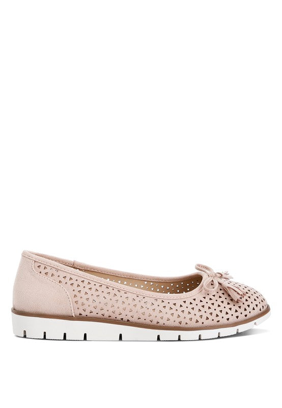 Outside side view of blush Pacer vegan leather ballerina flats highlighting the perforated design and bow embellishment.