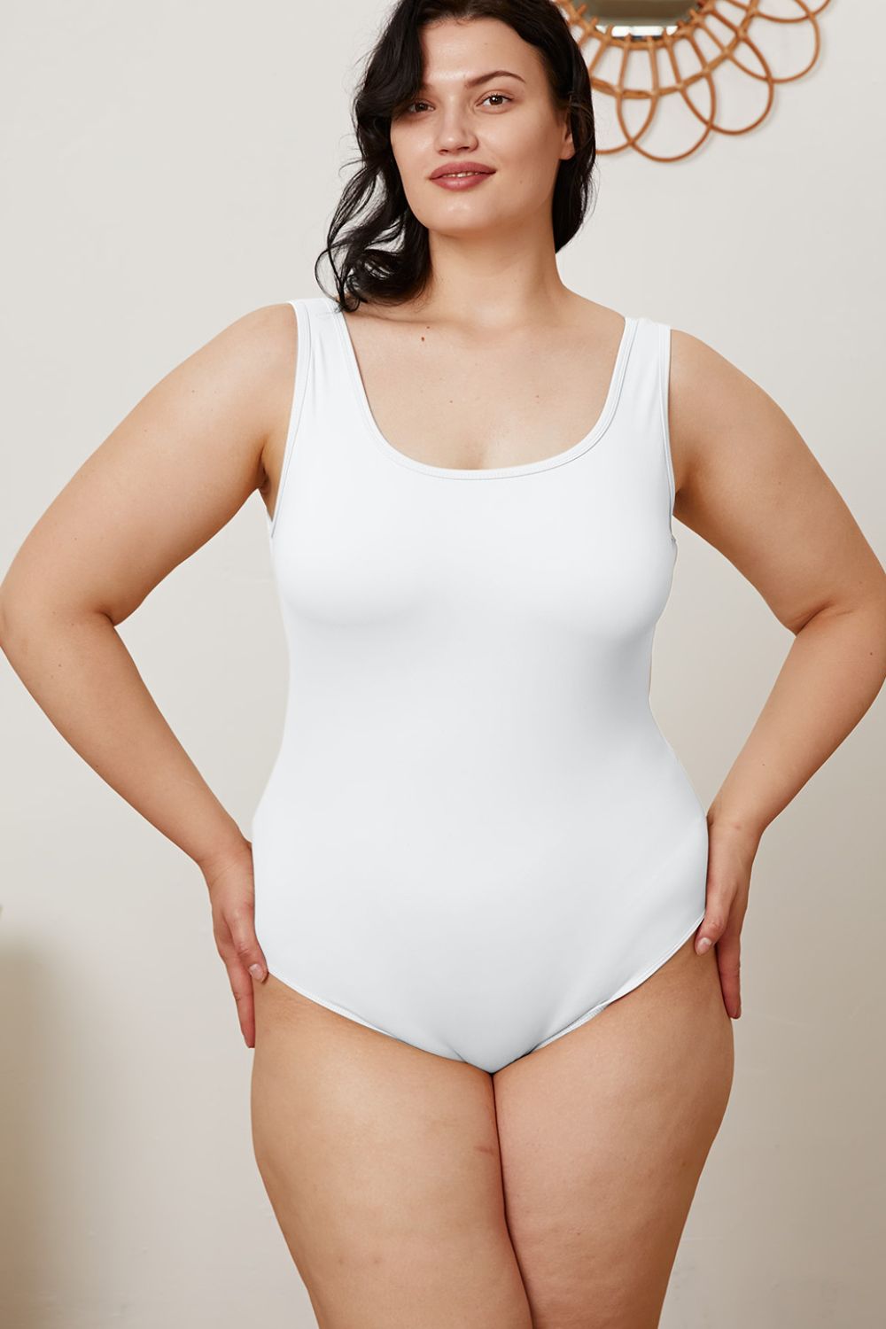 Plus size model in Sarah White Bodysuit highlighting flattering square neckline.