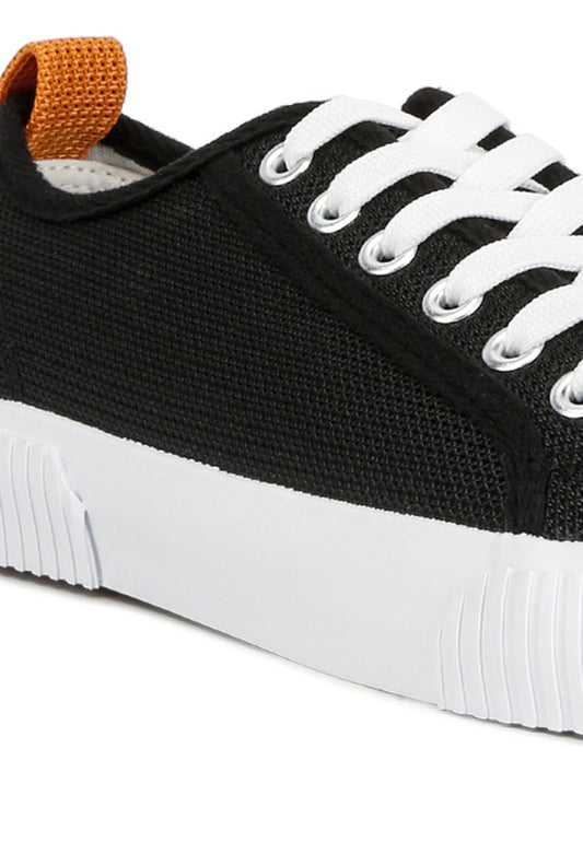 Close-up of black Georgie Chunky Sole Sneakers showing knitted upper and lace-up detail.
