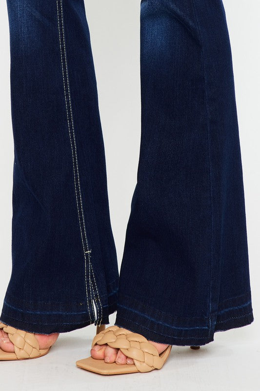 Close-up view of Hester Flare Jeans hem detail and wide flared legs in dark wash denim.