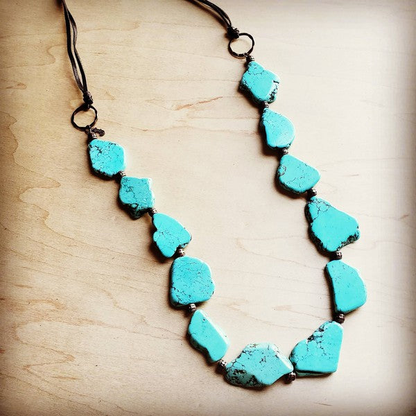 Bold turquoise stones suspended from copper hoops, finished with genuine leather ties. Adjustable length from 30" to 36" with a self-tie closure.