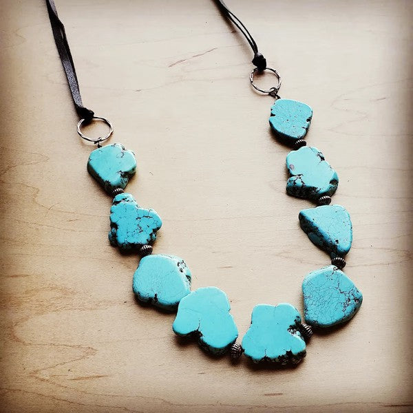 Bold turquoise stones suspended from copper hoops, finished with genuine leather ties. Adjustable length from 30" to 36" with a self-tie closure.