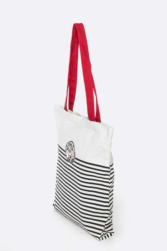 Side view of Girl Gang Cotton Canvas Tote with red handle, showing striped fabric and bold patch detail.