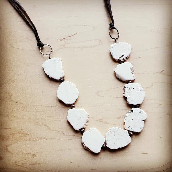 White turquoise slab necklace with copper hoops and leather fringe closure for adjustable boho style.