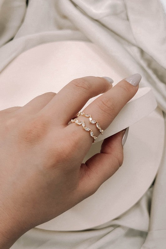 Woman wearing Stone Petal Double Layer Adjustable Ring in 18k gold plating with sparkling petal-shaped stones.