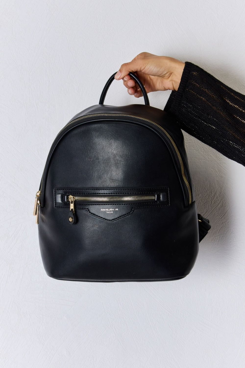 Straight-on front view of Garris black vegan leather backpack with zippered pockets.