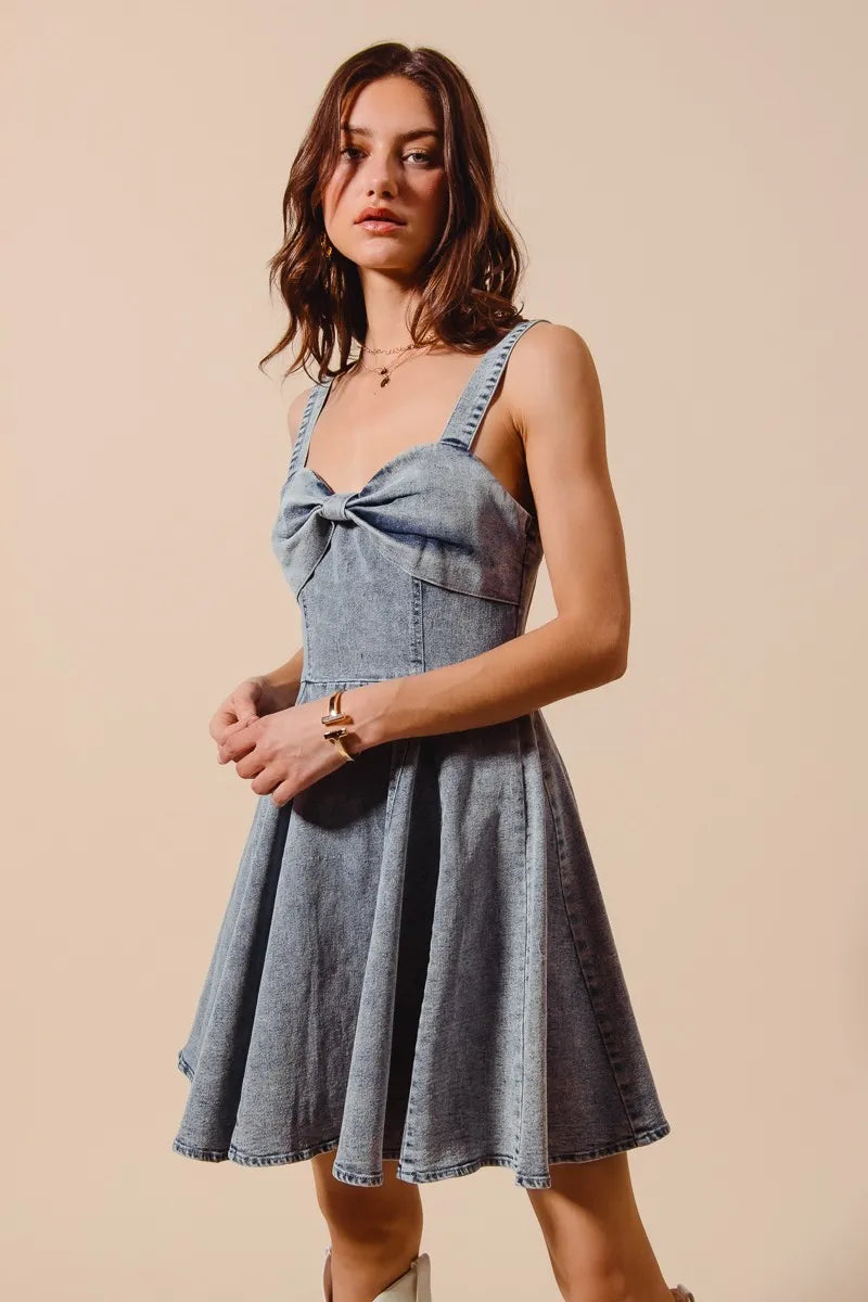 Angled side shot of Cassidy Mini Dress highlighting the flare and structured denim fabric.