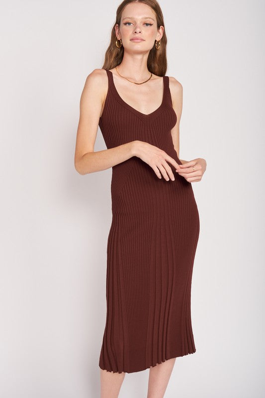 Woman wearing chocolate midi dress with open back and sleek, curve-hugging fit.
