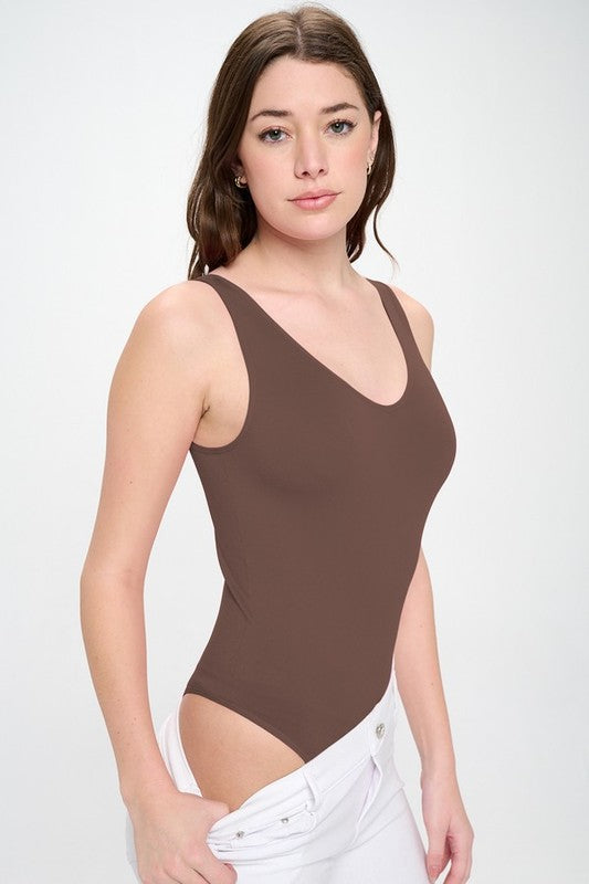 Model wearing the Coffee Tru V-Neck Tank Bodysuit, angled front and side view showcasing reversible neckline and sleek, seamless fit.