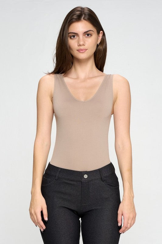 Woman wearing the Nude Tru V-Neck Tank Bodysuit, back side view highlighting thong cut and sleek lines.