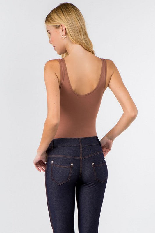 Back view of model wearing the Coffee Tru V-Neck Tank Bodysuit with jeans, highlighting thong cut and fitted silhouette.