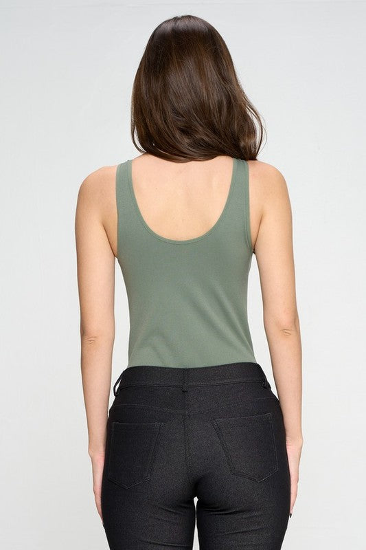Back view of Olive Tru V-Neck Tank Bodysuit worn with black jeans, highlighting thong cut and seamless construction.