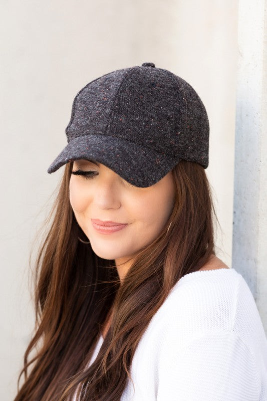 Woman wearing Faryn Fall Tweed Ball Cap in Black with low-profile fit and curved brim.