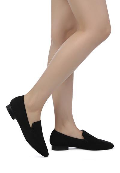 Woman modeling Julia Black Leather Pointed Loafers.