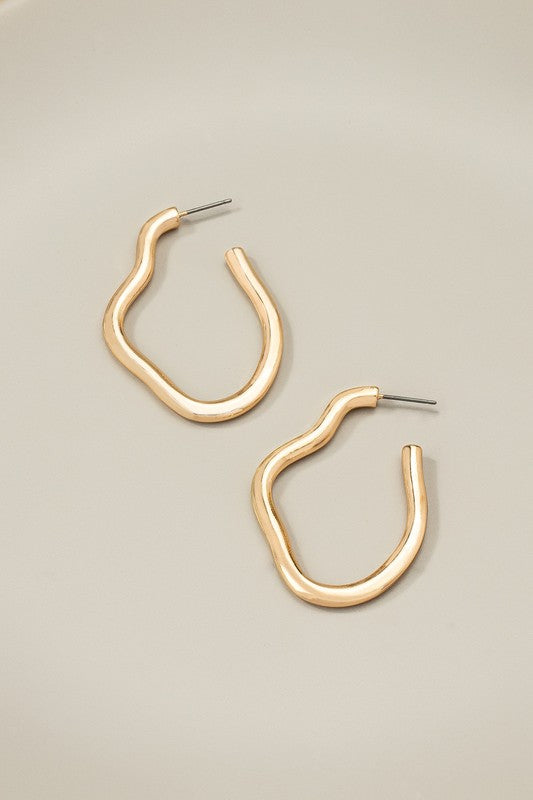 Nixi Irregular Metal Hoop Earrings in shiny gold finish, displayed side by side on a flat surface.