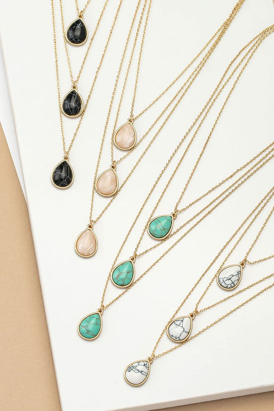 orina Three Layer Teardrop Stone Pendant Necklaces in black, white, pink, and turquoise displayed side by side flat lay.