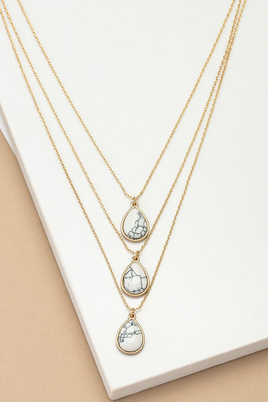 Torina Three Layer Teardrop Stone Pendant Necklace in white with layered chains and small teardrop stone pendant.