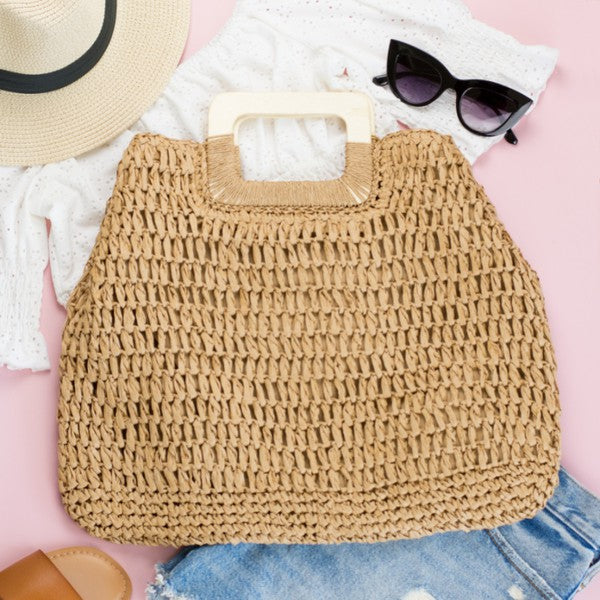 Elinie Oversized Straw Tote showing spacious interior, natural wood handles, and chic woven texture.