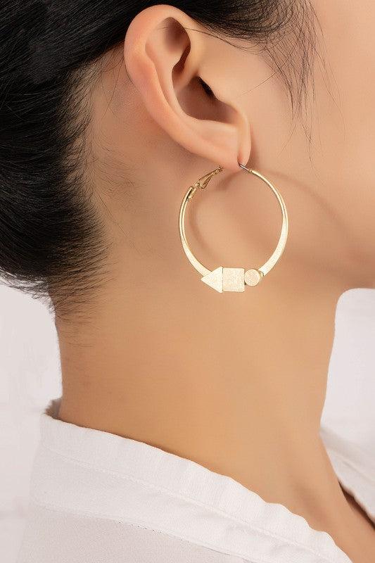 Woman wearing worn gold Geo Shapes Flat Hoop Earrings, showcasing their sleek, contemporary design.