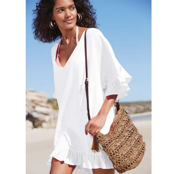 White Solymar ruffle sleeve beach cover-up tunic with sheer fabric, perfect for layering over swimwear.