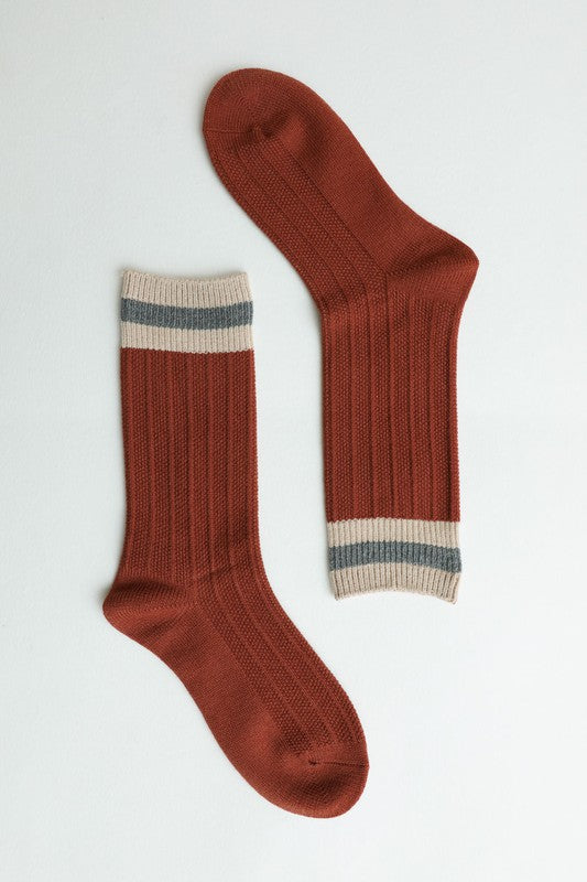 Flat lay of rust Simone Color Block Socks with striped cuff detail