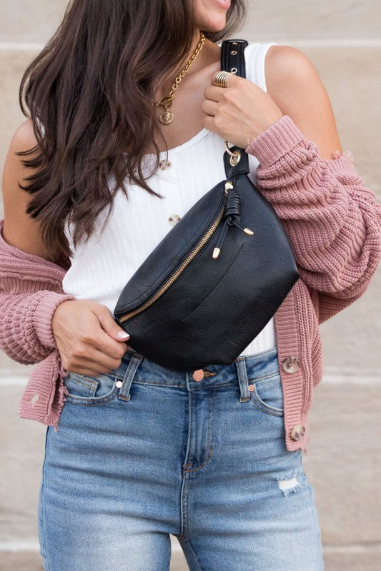 Black Luxie Convertible Sling Belt Bag worn crossbody with chain accent.