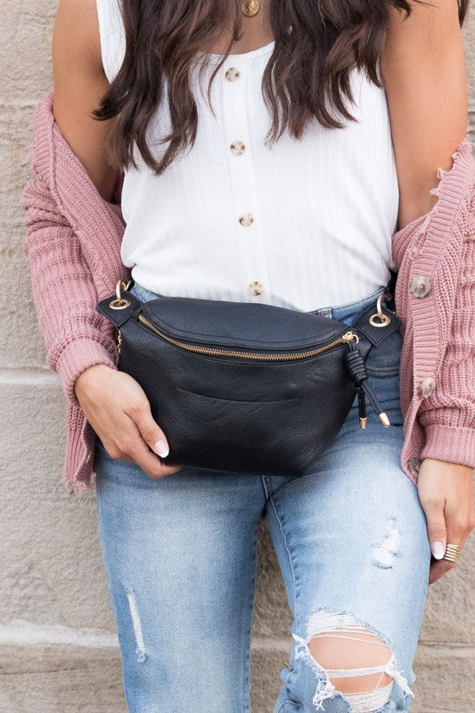 Black Luxie Convertible Sling Belt Bag styled at waist with vegan leather strap.