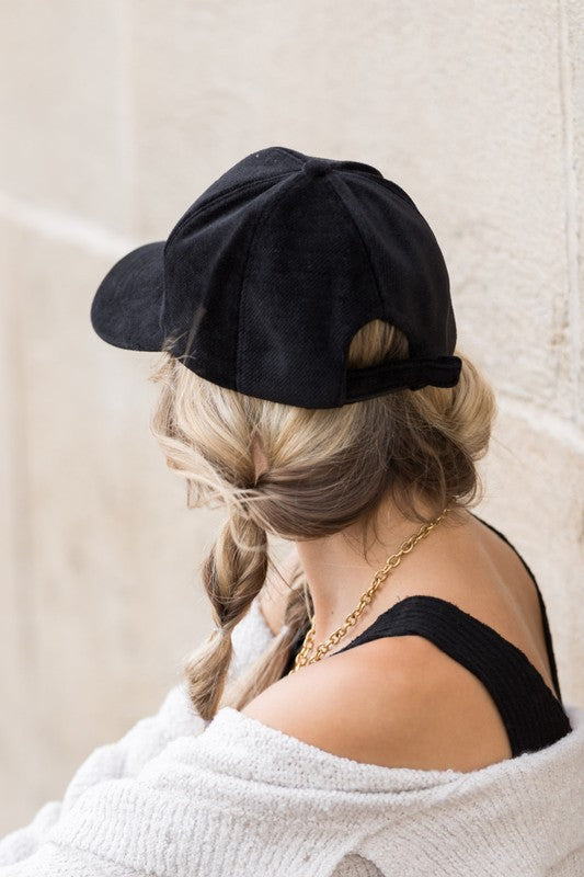 Black velour ball cap back view showing adjustable velcro strap and crown.