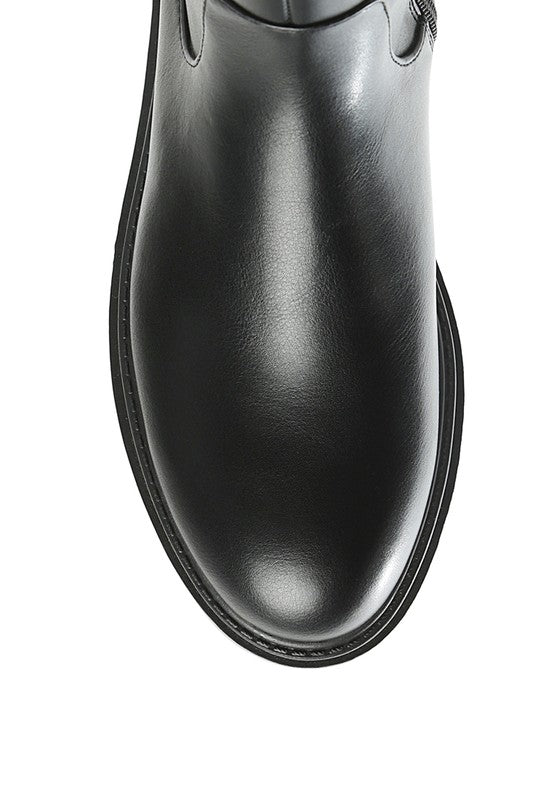 Black platform knee-high boots with a round toe, crafted from vegan leather. Featuring a zipper closure for easy wear, a 2" heel, and a durable TPR sole.