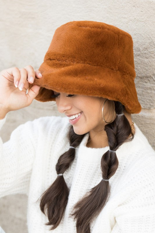 Side profile of woman wearing Izzie Plush Bucket Hat in Camel, cozy fall hat with soft plush finish