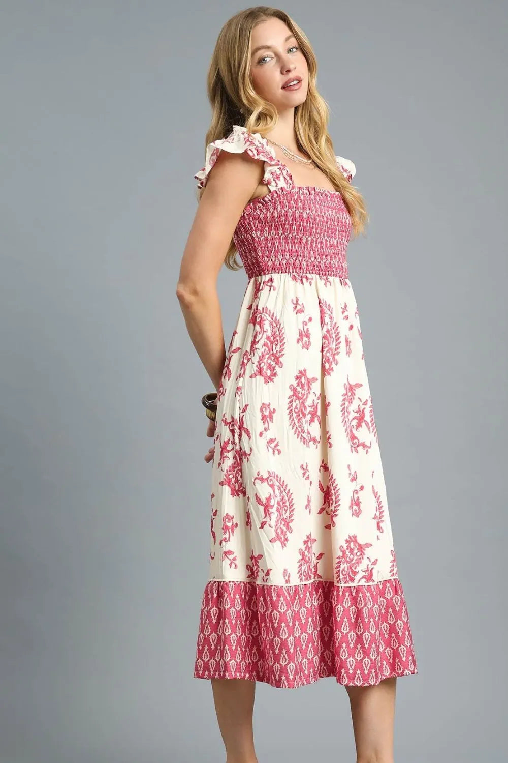 Side view of Isabelle Midi Dress highlighting flowy tiered skirt, ruffled sleeve detail, and flattering smocked bodice.