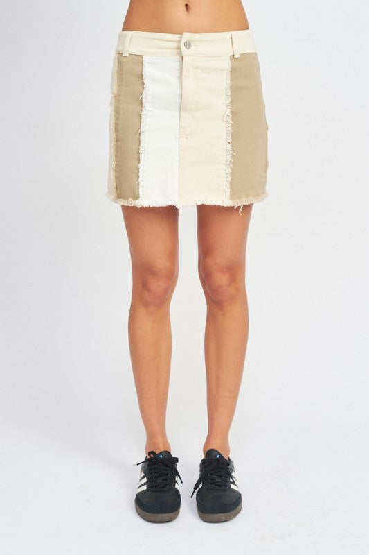 Front view of Kassiani High Rise Mini Skirt in Natural Combo with bold color block design and raw hem.