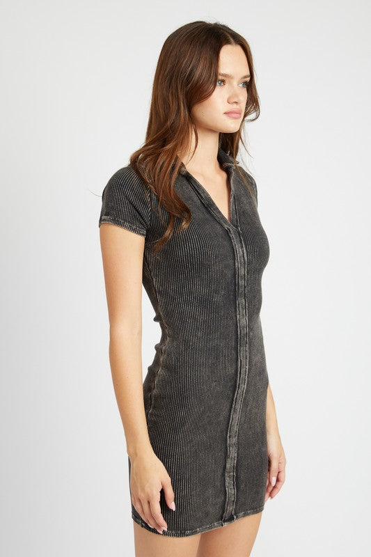 Side view of Gretchen Exposed Seam Mini Dress in black, showing fitted shape and short sleeves.