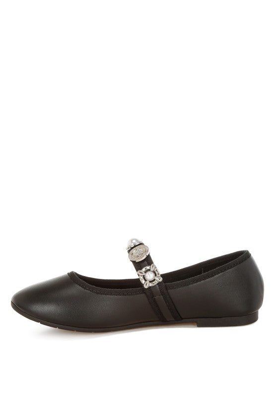 Side view of black Kavana Mary Jane Flats highlighting the sleek profile and charm strap detail.