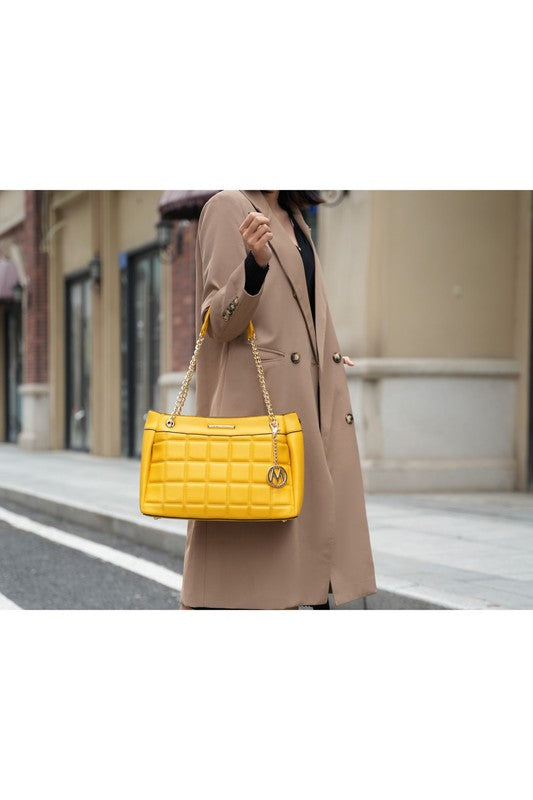 Woman holding Mabel Quilted Shoulder Bag in Yellow by MKF in crook of elbow.
