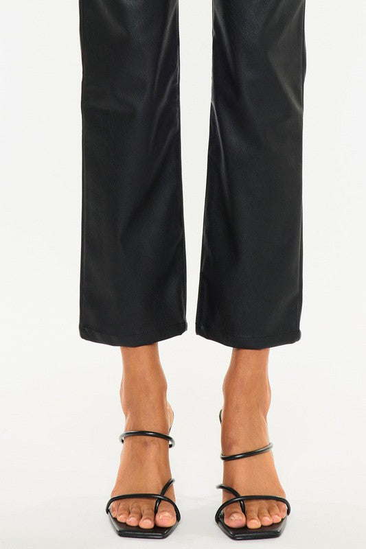 Close up of Luz Faux Leather Jeans cropped straight hem with polished faux leather finish.